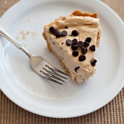 Cream cheese chocolate chip cake slice on white plate with fork, baked Bree dessert image.