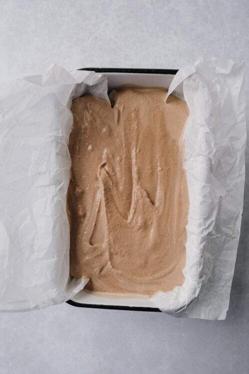 Creamy homemade chocolate ice cream in a lined container, ready to freeze and enjoy.