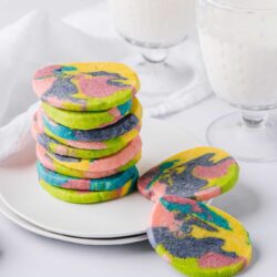 Colorful marble sugar cookies with pastel swirls on a white plate; ideal for baking and dessert recipes.