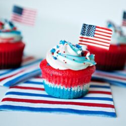 Bright red, white, and blue cupcake with American flag decoration for Independence Day celebrations.