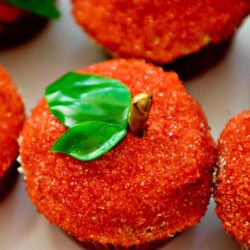 Fresh baked apple crumble cupcakes with caramelized apples and green edible leaves. Perfect for fall desserts.