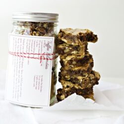 Homemade nut granola bars stacked next to a jar of granola, perfect for healthy snacks and breakfast.
