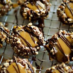 Butter pecan cookies drizzled with chocolate and topped with chopped pecans.