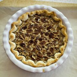 Creamy pecan pie in a flaky pie crust, ready to serve, baked by Baked Bree.