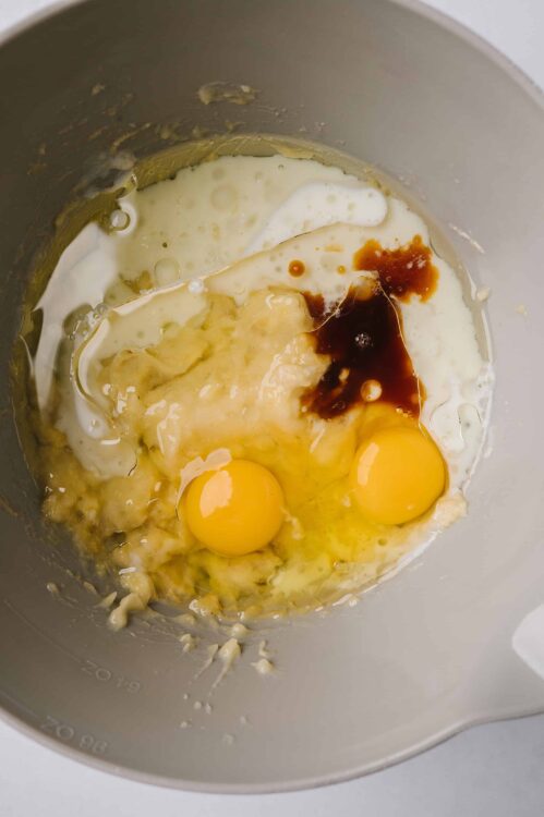 Eggs, vanilla, and brown sugar in a mixing bowl for baking.