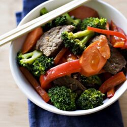 Steamed broccoli, carrots, and beef stir-fry in a white bowl, healthy Asian-inspired meal, fresh vegetables, savory dish, Baked Bree recipe.