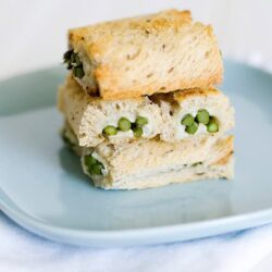 Soft homemade bread with green peas filling on a blue plate.
