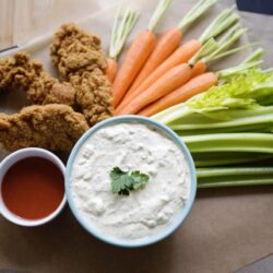 Crispy fried chicken tenders with fresh carrots, celery, and creamy ranch dip, perfect for lunch or snack.