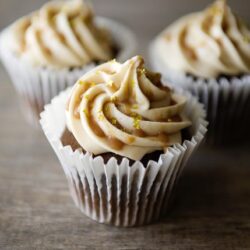 Buttery lemon cupcake with creamy frosting and lemon zest decoration, baked fresh for dessert or special occasions.