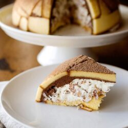 Cream-filled tiramisu cake with layered mascarpone and cocoa, perfect for dessert lovers.