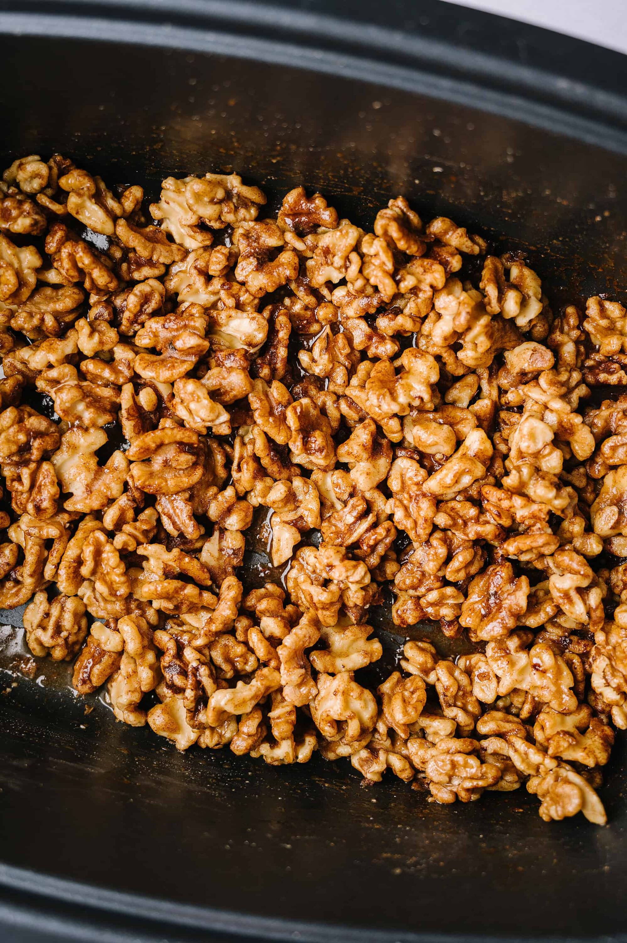 Crispy caramelized walnuts in a slow cooker for baking recipes.