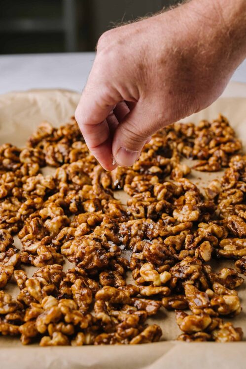 Crunchy caramel walnut clusters on parchment paper.