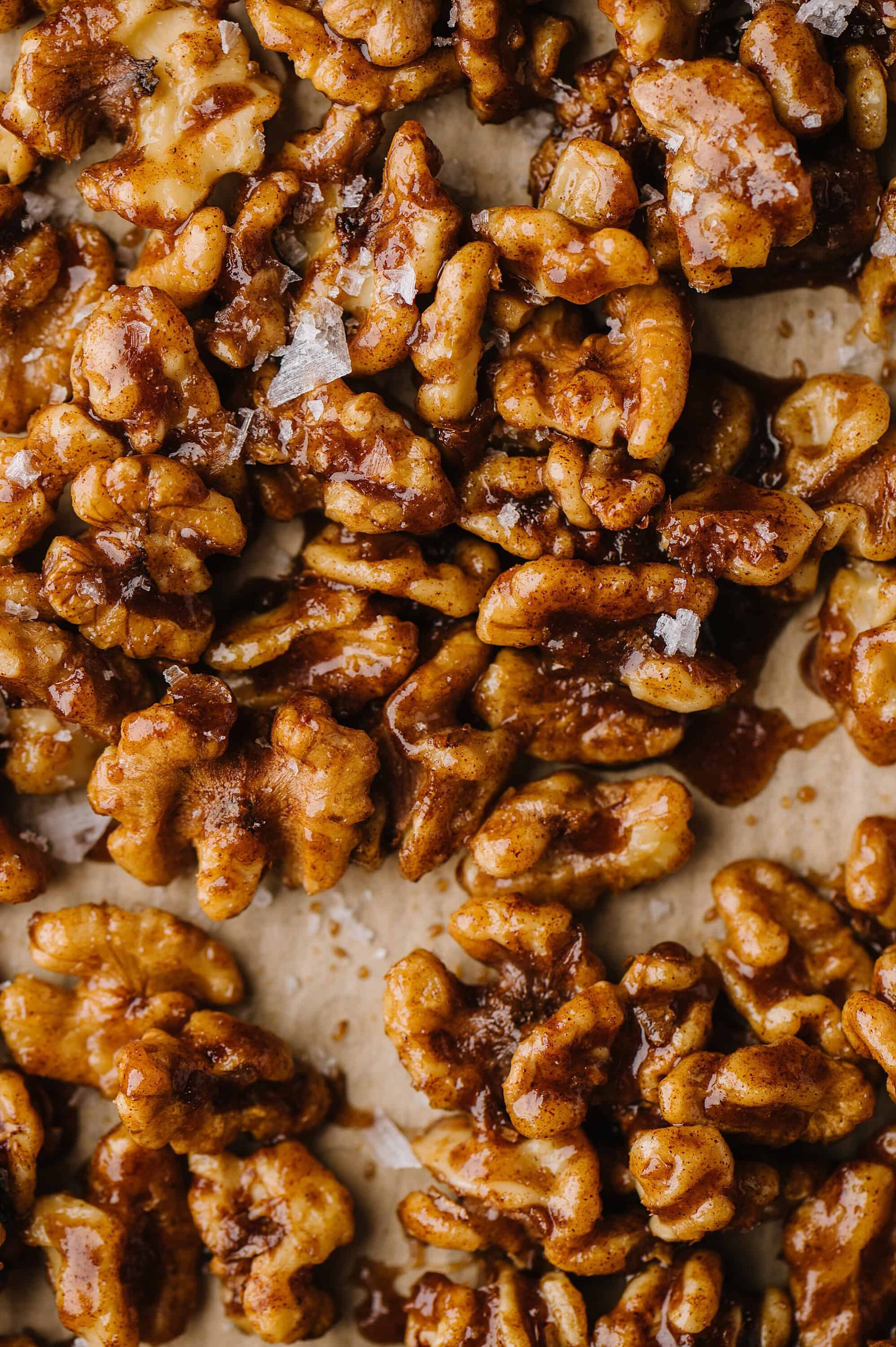 Candied walnuts on baking sheet for baking or snacking.