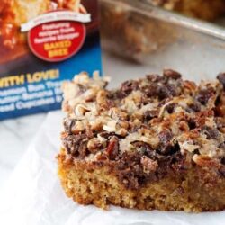 Butterscotch pecan crumb cake bar with caramel topping and chopped pecans on bakedbree.com.
