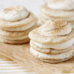Fluffy cinnamon-sugar cookies stacked on parchment paper, perfect for baking.
