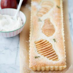 Golden pear galette on parchment paper, with fresh pears, baked to perfection. Perfect for dessert or a sweet snack.