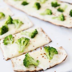 Broccoli and cheese flatbread crispy crust, baked to perfection with fresh broccoli florets and melted cheese.