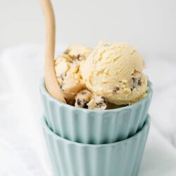 Creamy vanilla ice cream with chocolate chips in pastel bowls.
