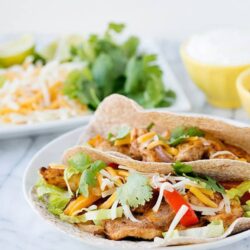 Fresh chicken fajitas with colorful peppers and shredded cheese, served in soft tortillas. Perfect for quick and flavorful homemade dinners.
