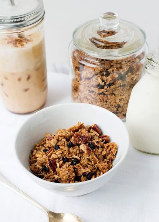 Homemade granola with dried fruits and nuts in a white bowl.