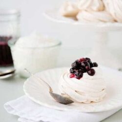 Creamy homemade meringue topped with mixed berries for a delicious dessert or snack.