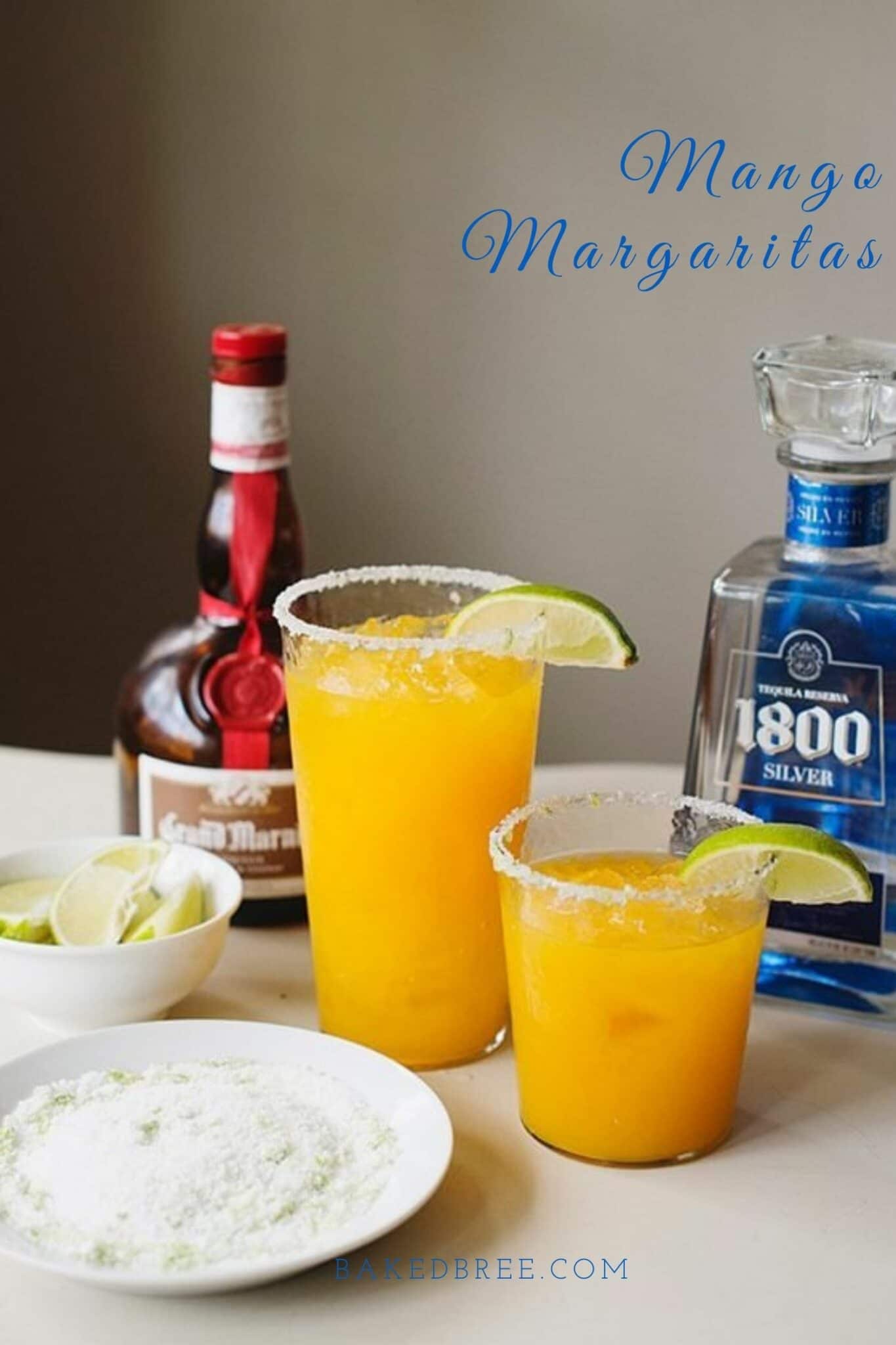 Refreshing Mango Margaritas with lime wedges, salt-rimmed glasses, and tequila on a bar countertop.