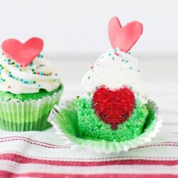 Sweet Valentine's Day cupcakes with colorful sprinkles and heart toppers, perfect for romantic celebrations.