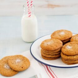 Buttery homemade cookies with a glass of milk, perfect for a cozy snack. Deliciously baked cookies from Baked Bree.