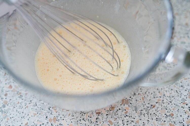 Creamy batter with whisk in glass mixing bowl, baking ingredients, cooking process, kitchen: Baked Bree.