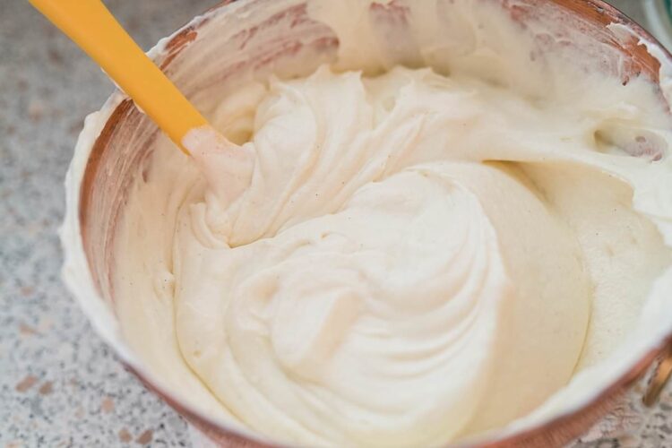 Cream cheese frosting in a mixing bowl ready for baking.