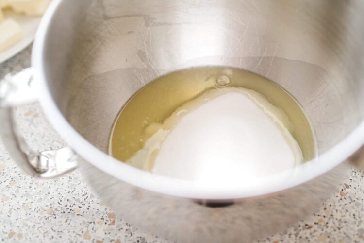 Cream and butter melting in a stand mixer bowl for baking recipes.
