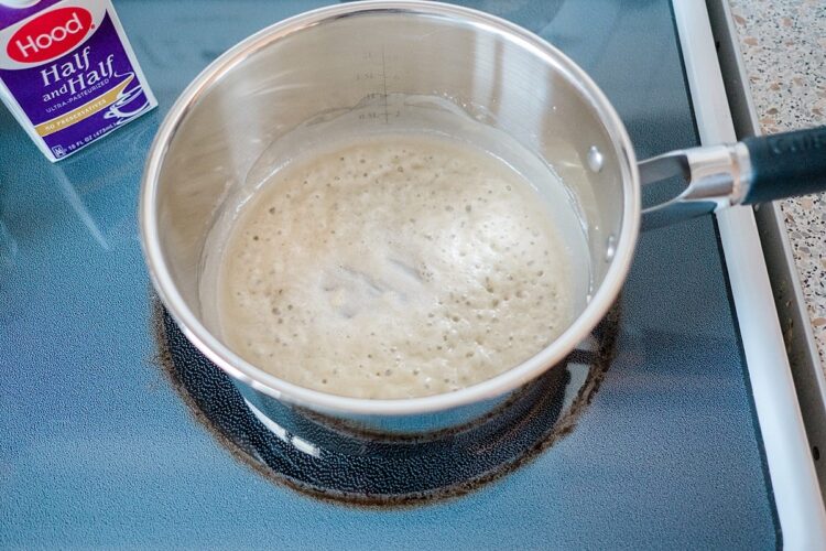 Frothing milk on stove for baking recipes, large stainless steel saucepan.