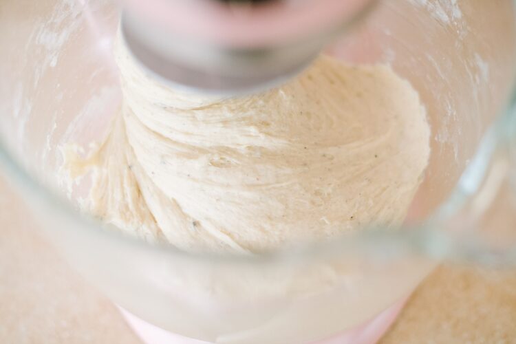 Creamy cake batter inside a stand mixer for baking recipes.