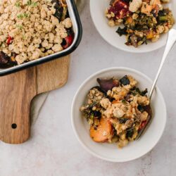 Savory vegetable crumble casserole in white bowls, baked veggie dish with crispy topping, healthy vegetable bake recipe, baked vegetable casserole with crumble topping, relevance.