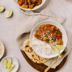 Creamy Indian Chicken Curry with Rice and Fresh Lime Slices.