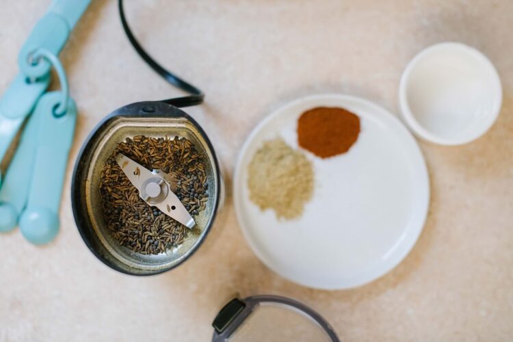 Ghts of sunflower and flax seeds on a countertop with spices and a small bowl of milk for baking or cooking.