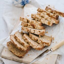 Butterscotch Crunch Toffee Biscotti with Coffee on a Wooden Cutting Board.