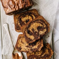 Chocolate marble pound cake, sliced for serving, with a side of creamy Nutella spread.