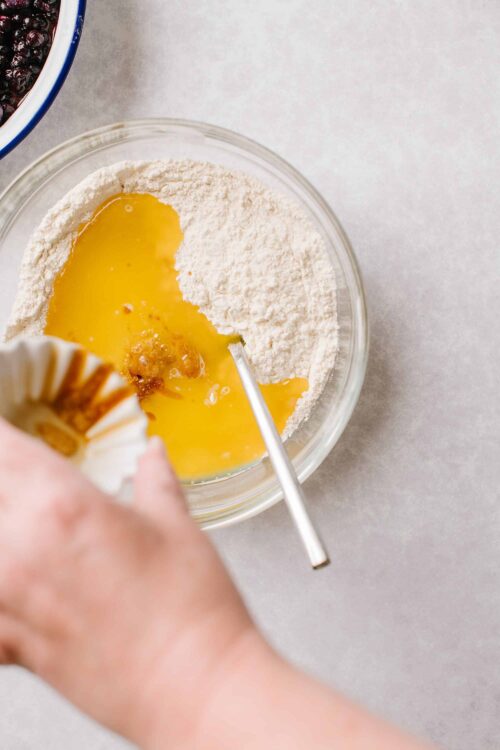 Flour and eggs in mixing bowl for baking fresh homemade bread or pastry.