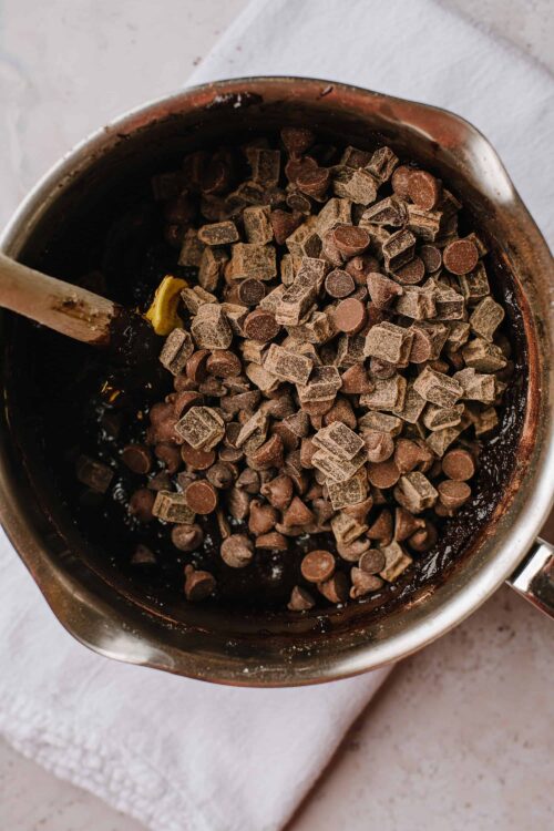 Rich chocolate chips melting in a saucepan for baking or hot chocolate.