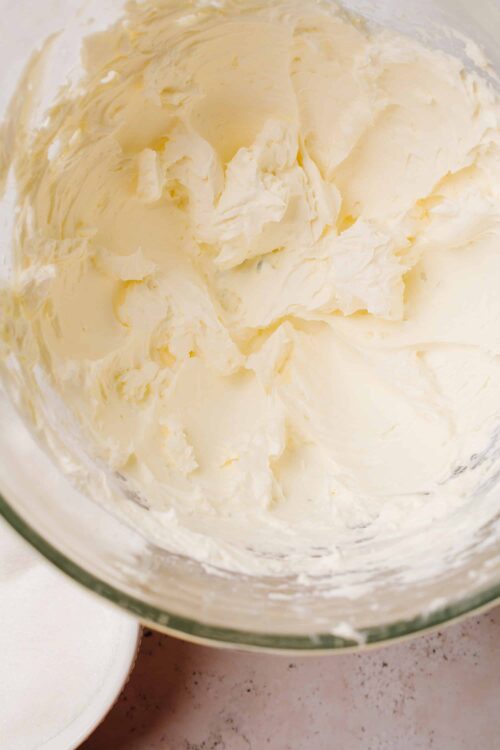 Creamy homemade butter in a glass bowl, ready for baking or cooking. Perfect for classic baking recipes and spreading.