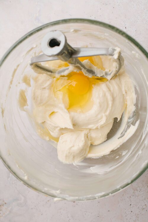Cream cheese and butter mixture in a mixing bowl for baking recipes.