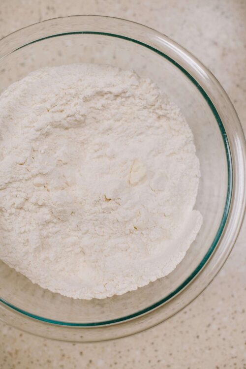 Flour in a glass bowl for baking recipes, close-up of baking ingredients.