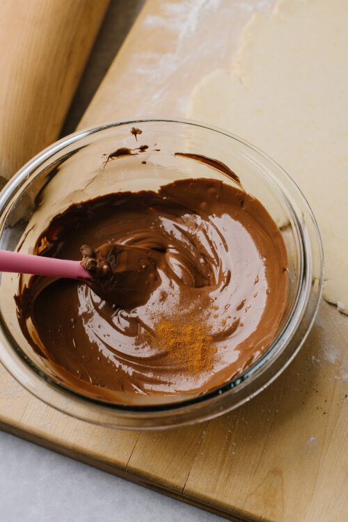 Creamy chocolate filling in a glass bowl for baked dessert recipes.