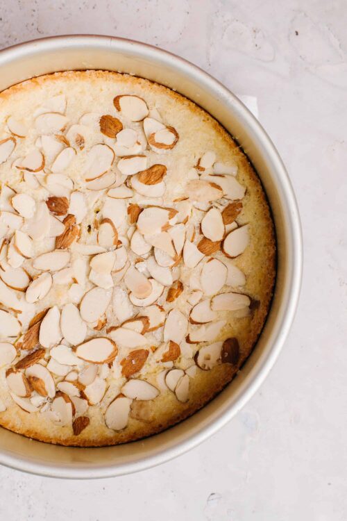 Creamy almond-topped dessert in a round baking dish, perfect for baking and dessert recipes.