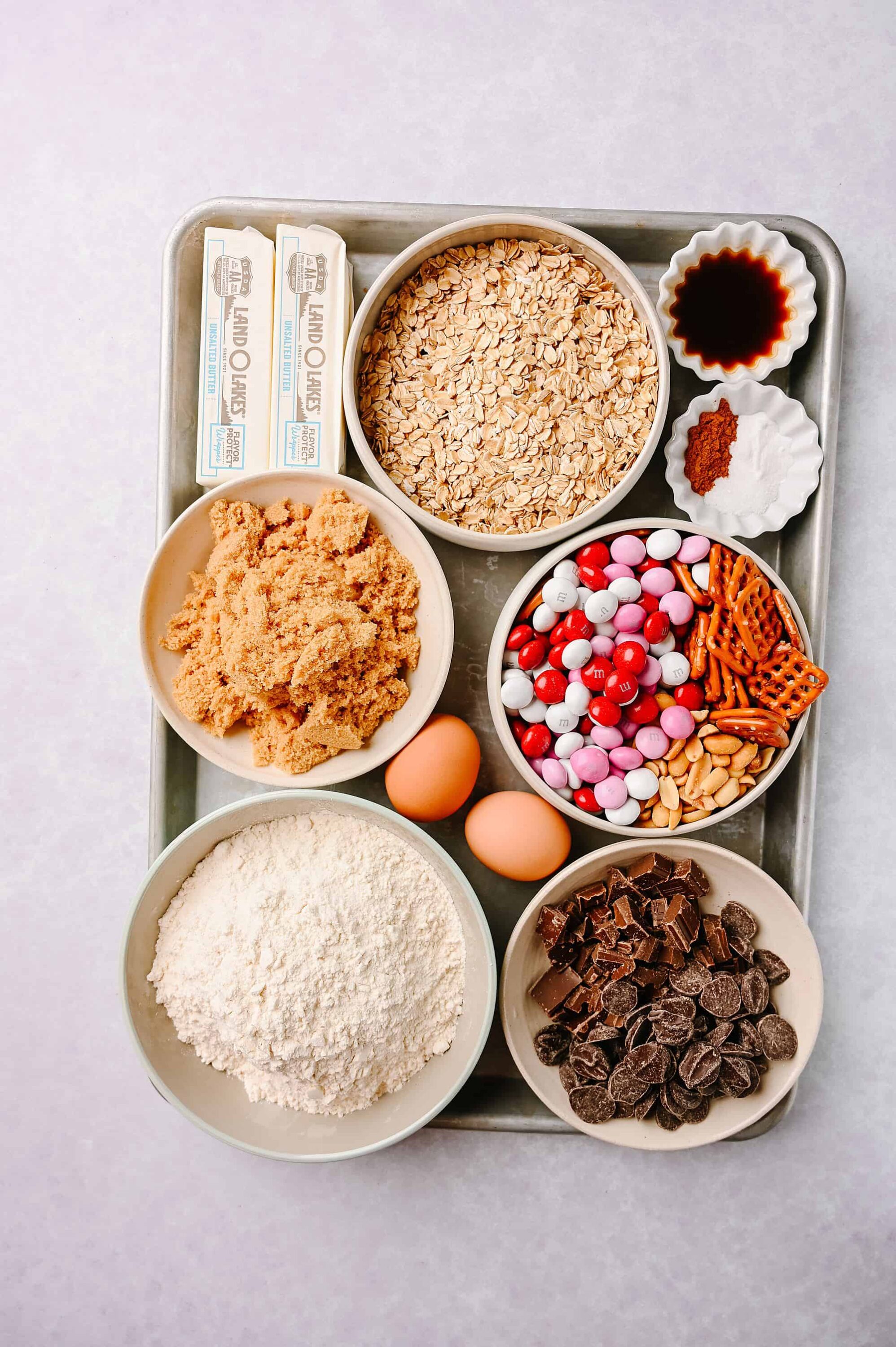 Fresh baking ingredients including oats, chocolate, candies, eggs, and baking staples.