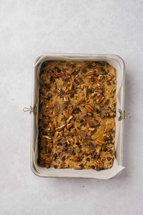 Butterscotch Pecan Blondies with Chocolate Chips in a baking pan.