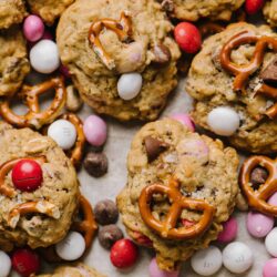 Buttery cookie cookies with chocolate chips, pretzels, and colorful candies, perfect for holiday baking.