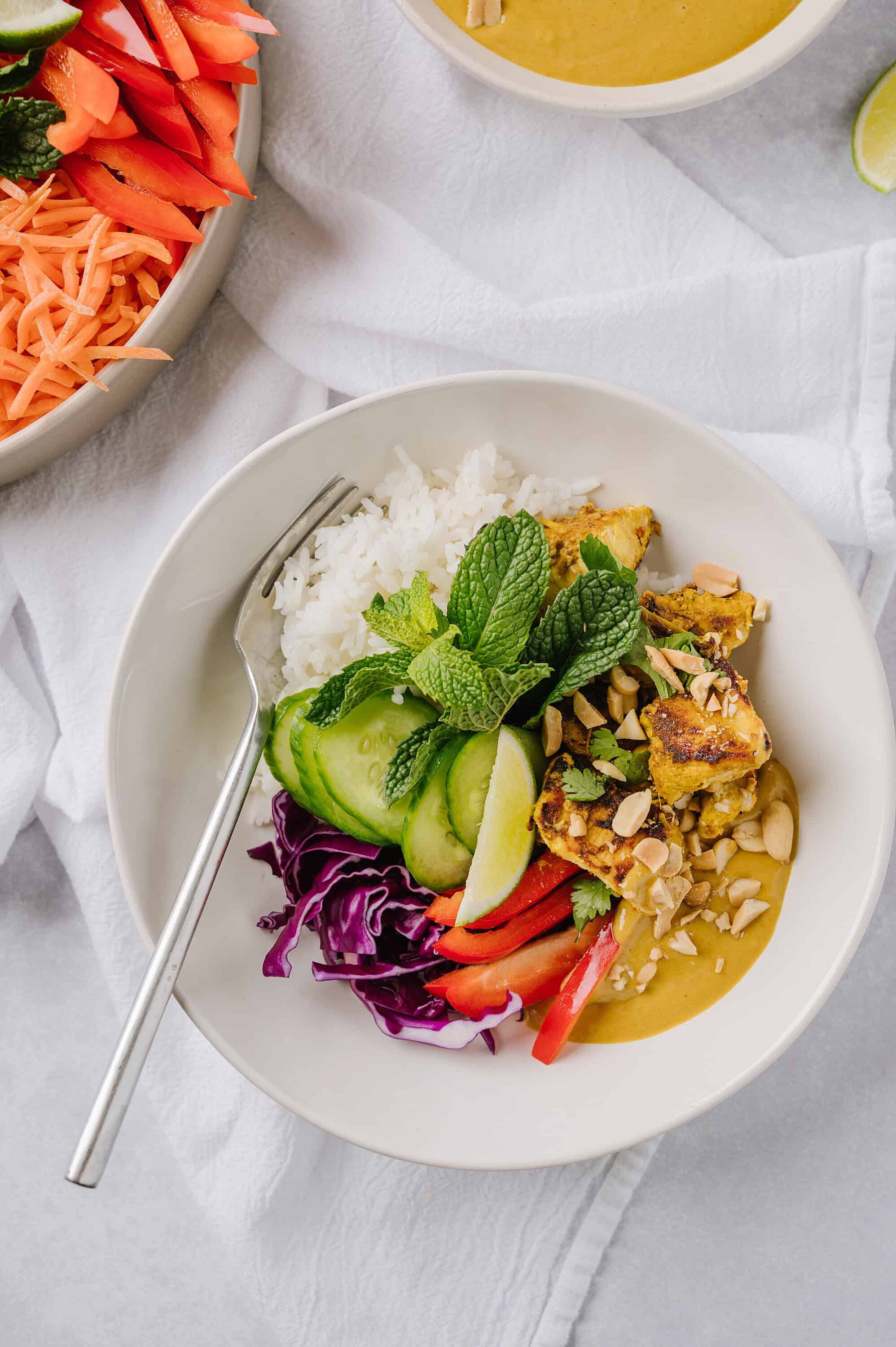 Fresh vegetable spring roll bowl with rice, herbs, and peanut sauce, healthy vegan Asian-inspired meal.