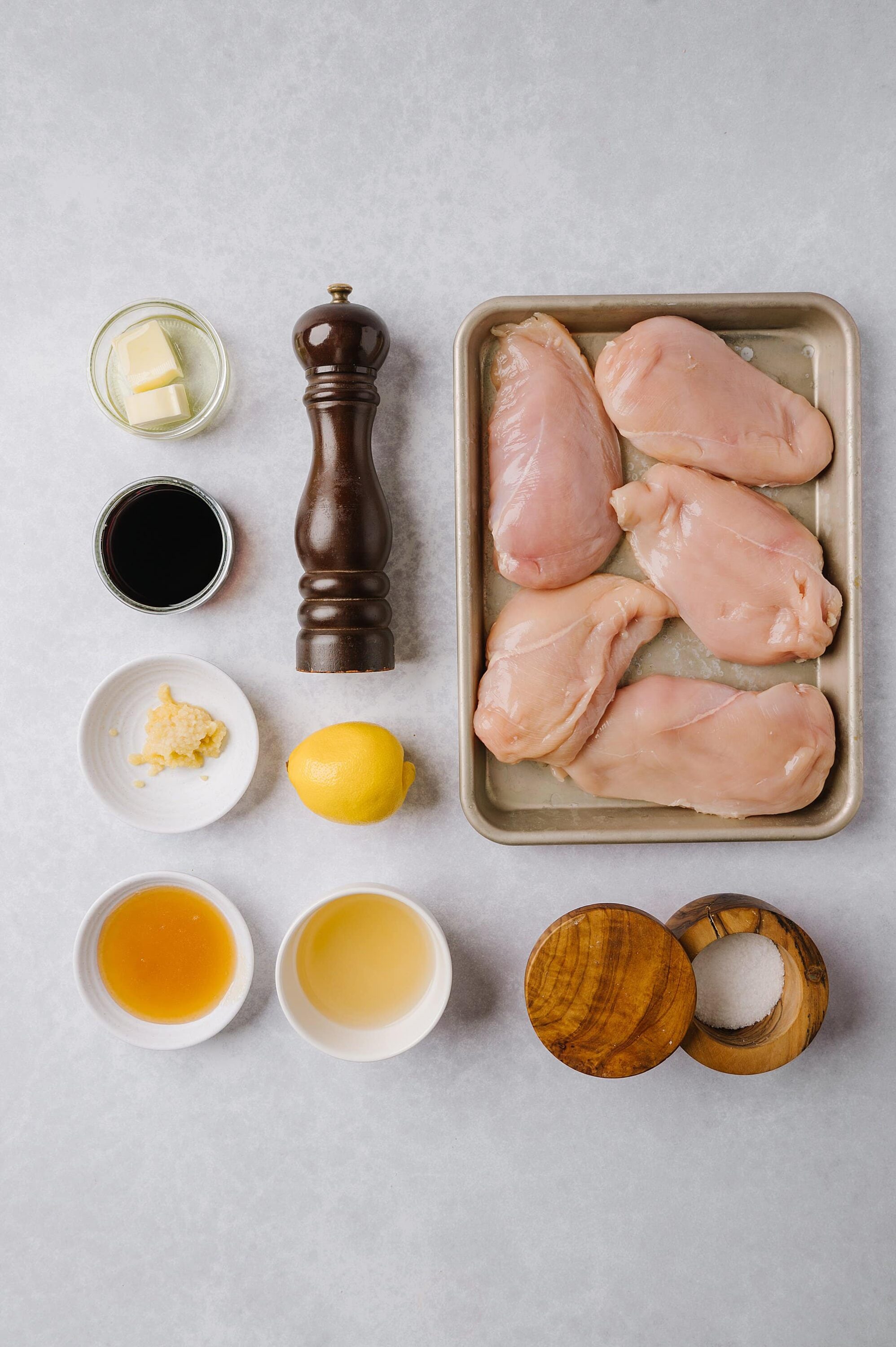 Chicken breasts with garlic, lemon, and herbs for baking.